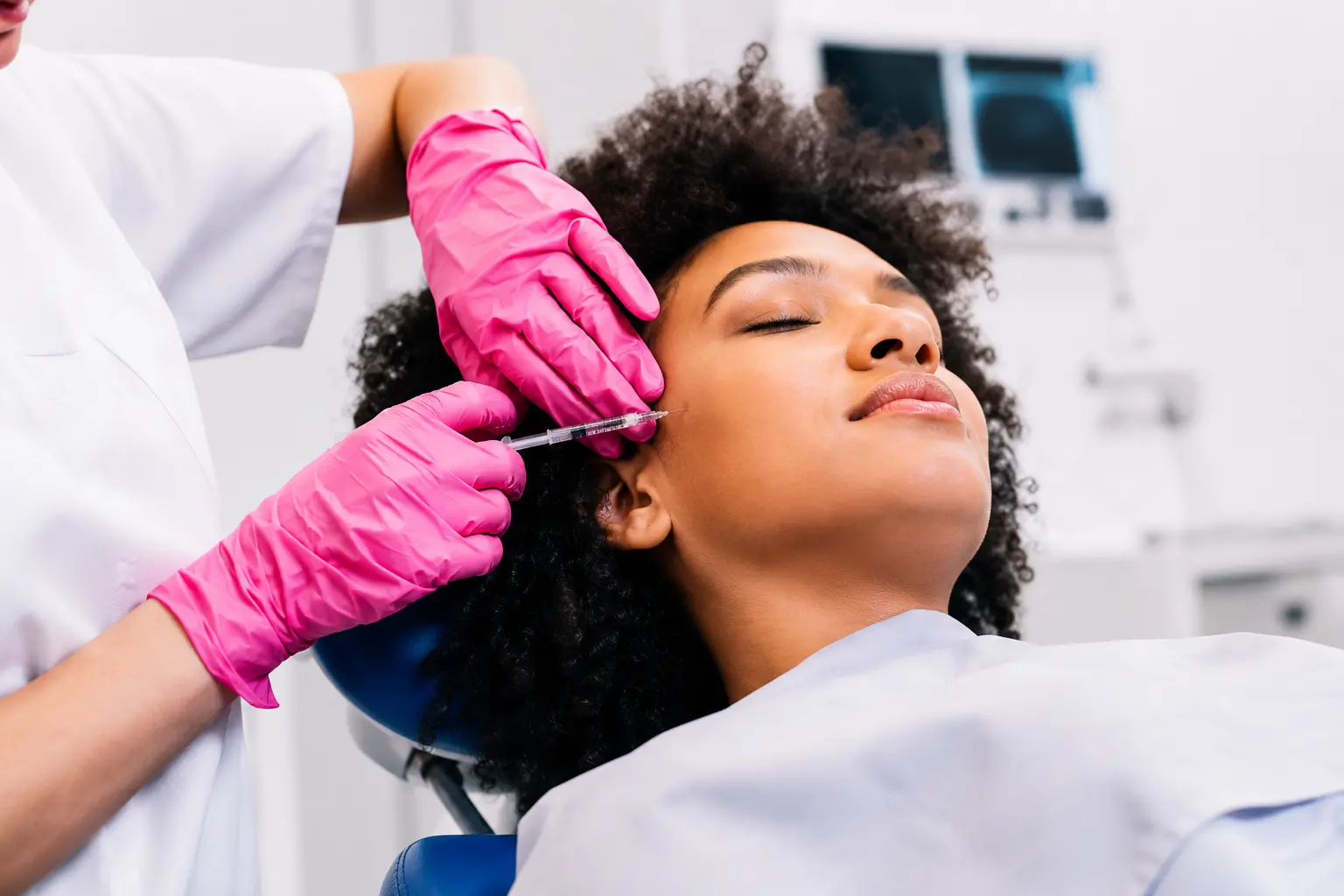 Client receiving a sculpting facial massage by an esthetician at a New York medical spa.