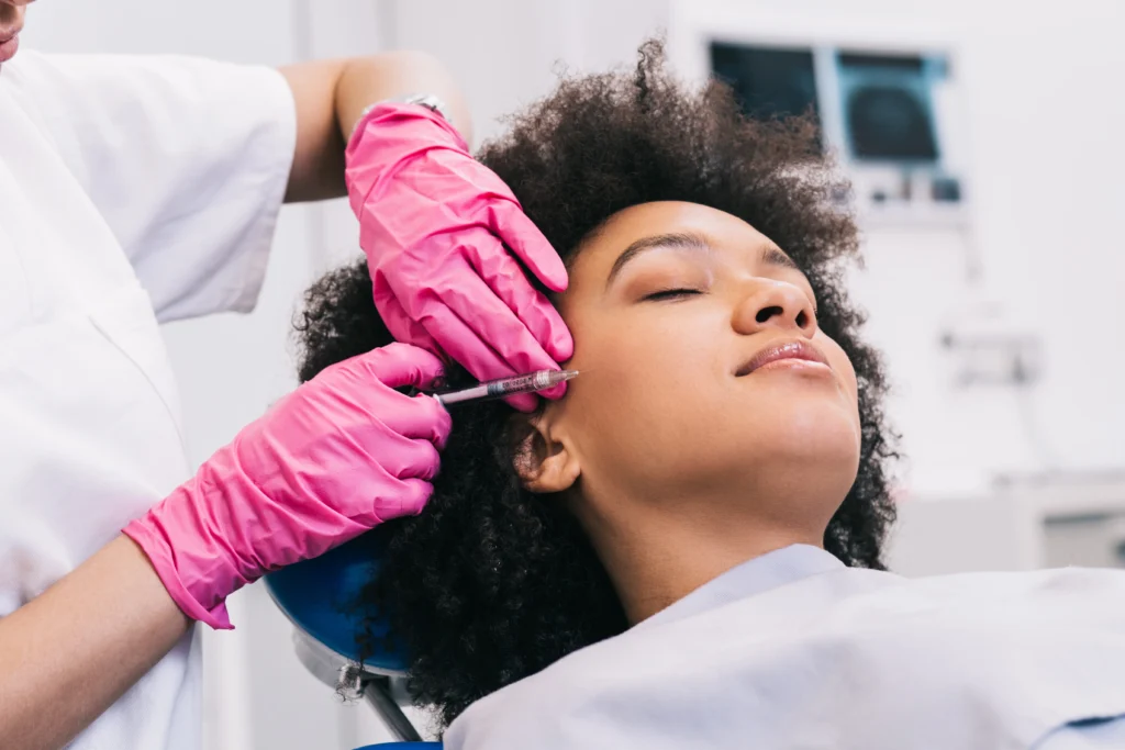 Client receiving a sculpting facial massage by an esthetician at a New York medical spa.